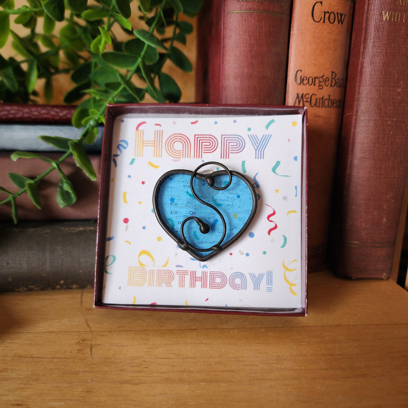 Aquamarine blue stained glass heart suncatcher in a gift box with birthday message card.