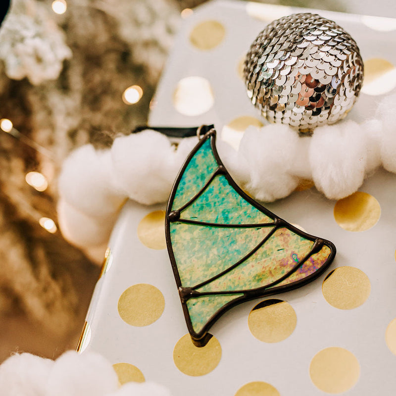 Whimsical Christmas Tree, stained glass ornament, made of green iridescent glass and place on a holiday package