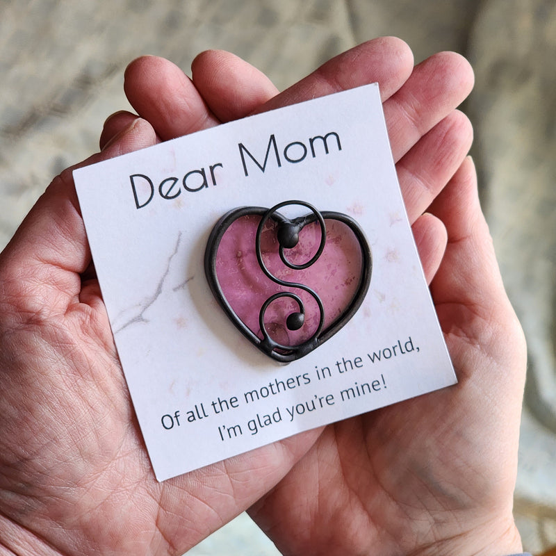 Pink tourmaline colored stained glass suncatcher on a Dear Mom message card, held in outstretched hands