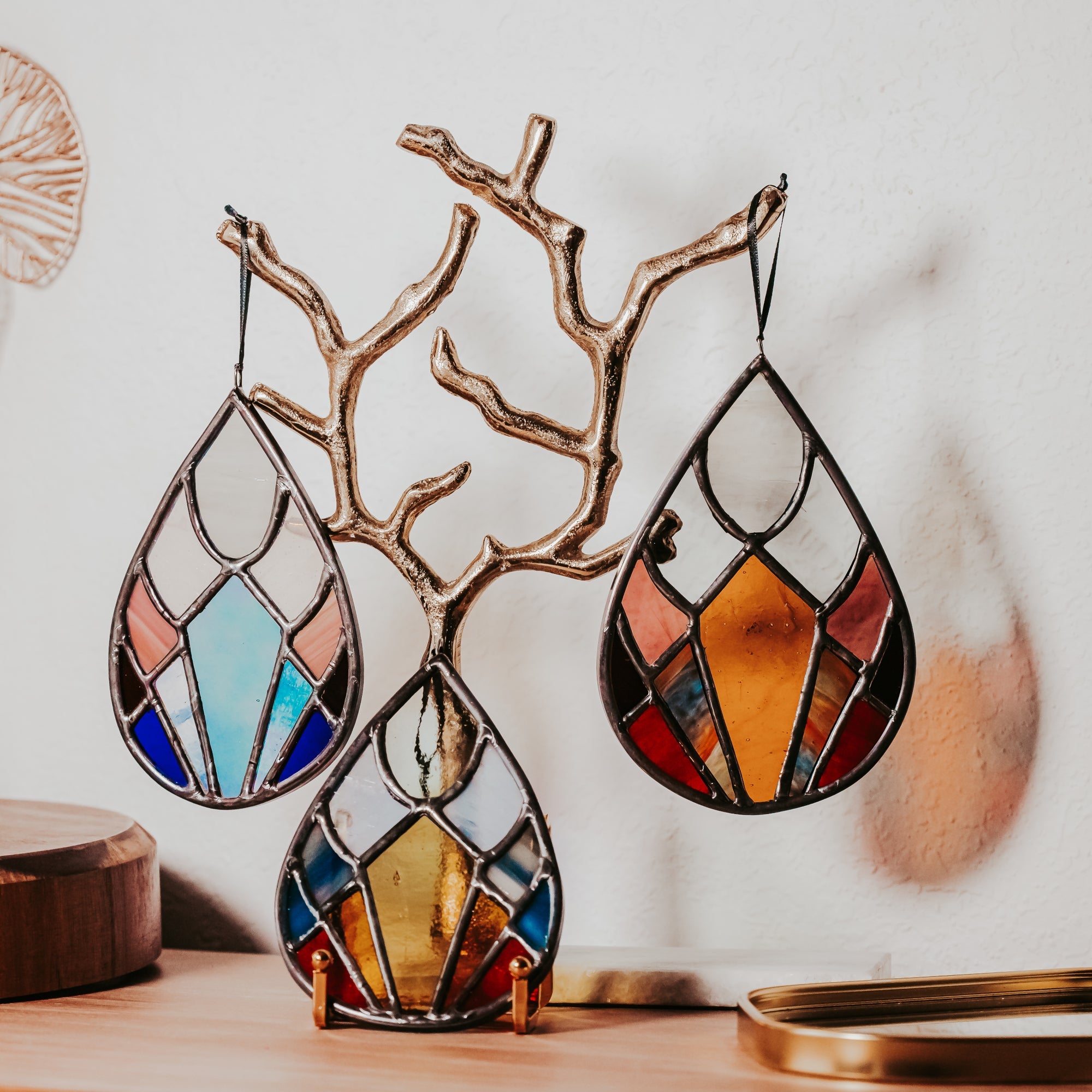Trio of Seasons Drops stained glass suncatchers, featuring Winter, Summer, and Fall