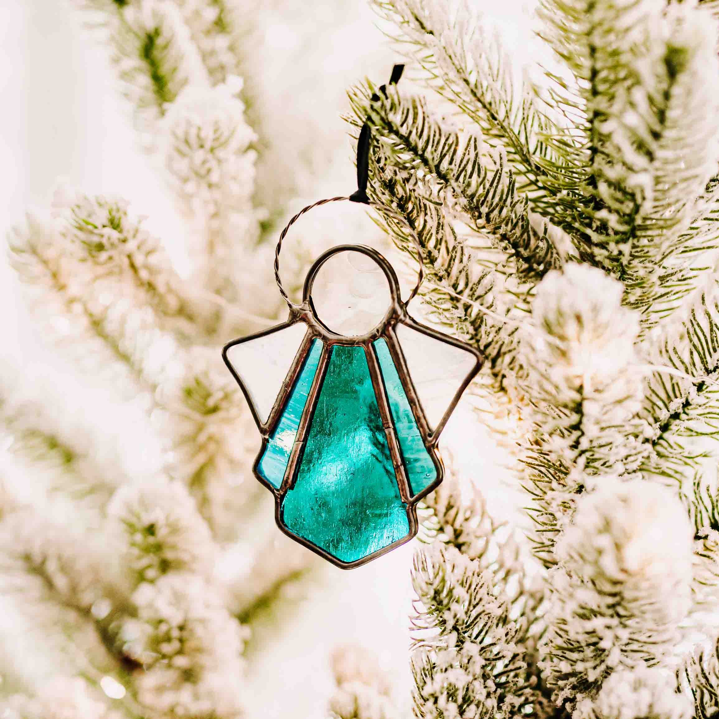 Blue and white stained glass angel suncatcher or ornament on holiday background