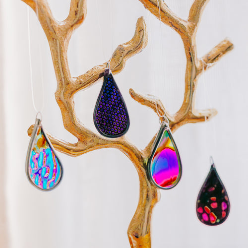 4 Colorful teardrop-shaped car charms on a decorative branch with a white background
