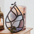 Decorative stained glass dove suncatcher on a table with a soft focus background