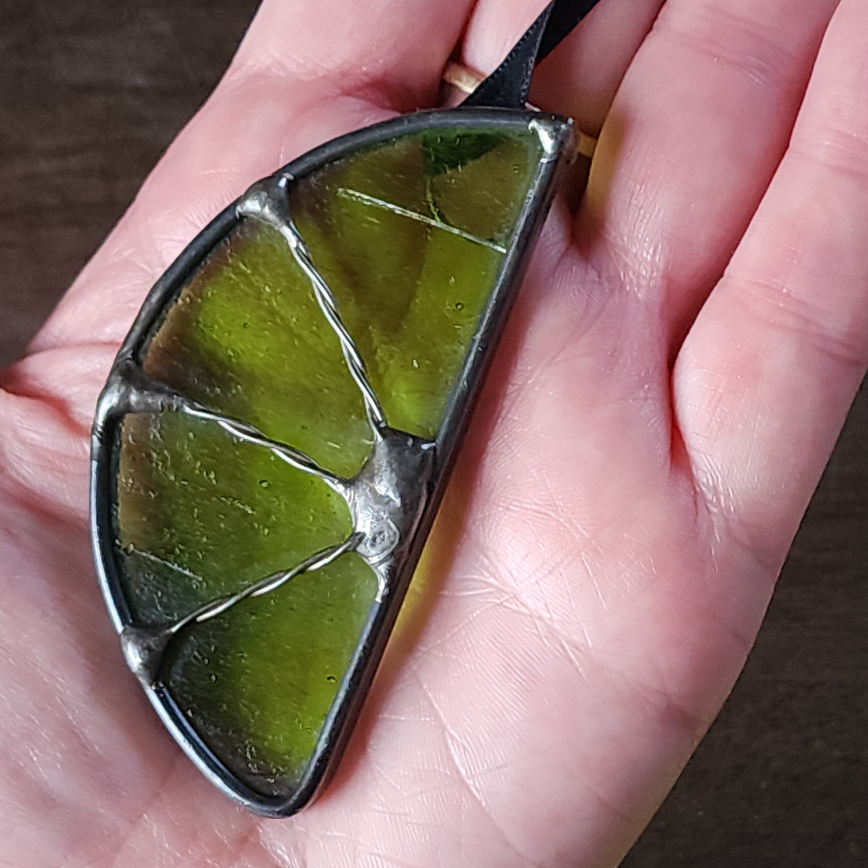 Green lime suncatcher held in a hand