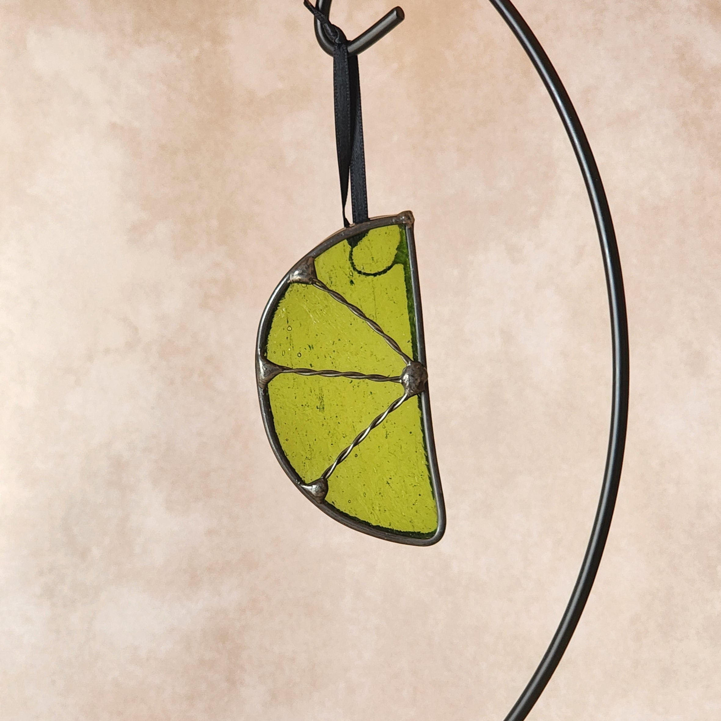 Green lime suncatcher against a beige background