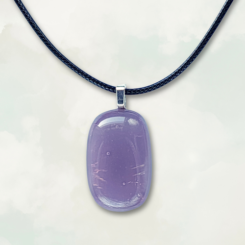 Iridescent purple pendant on a black cord against a white background