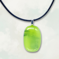 Iridescent lime green pendant necklace on a white background