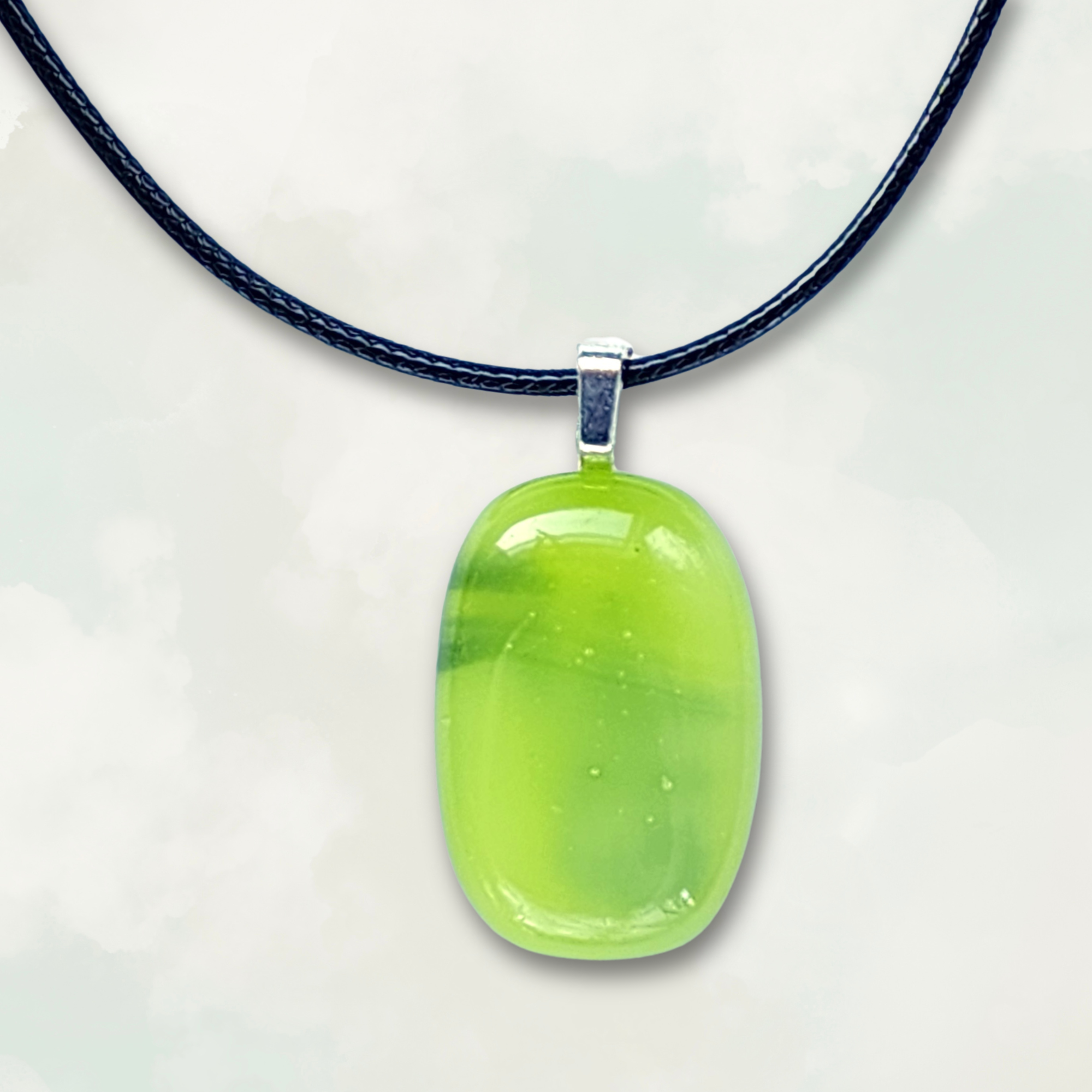 Iridescent lime green pendant necklace on a white background