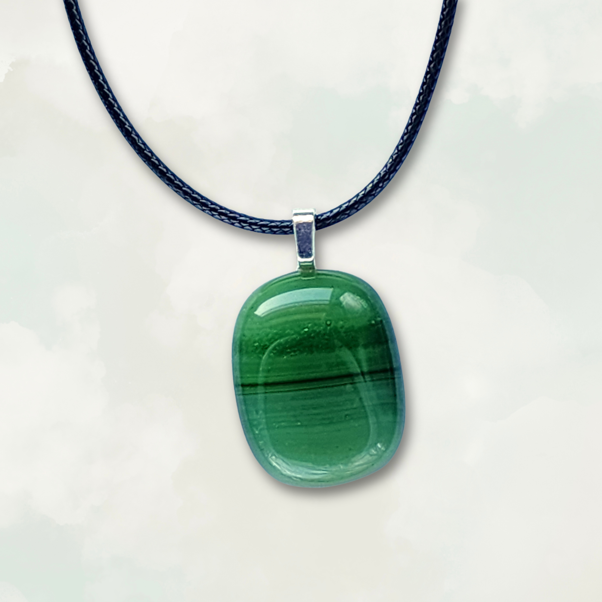 Striped green pendant necklace on a white background
