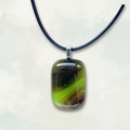 Pistachio green and chocolate brown rectangular pendant on a black cord against a white background