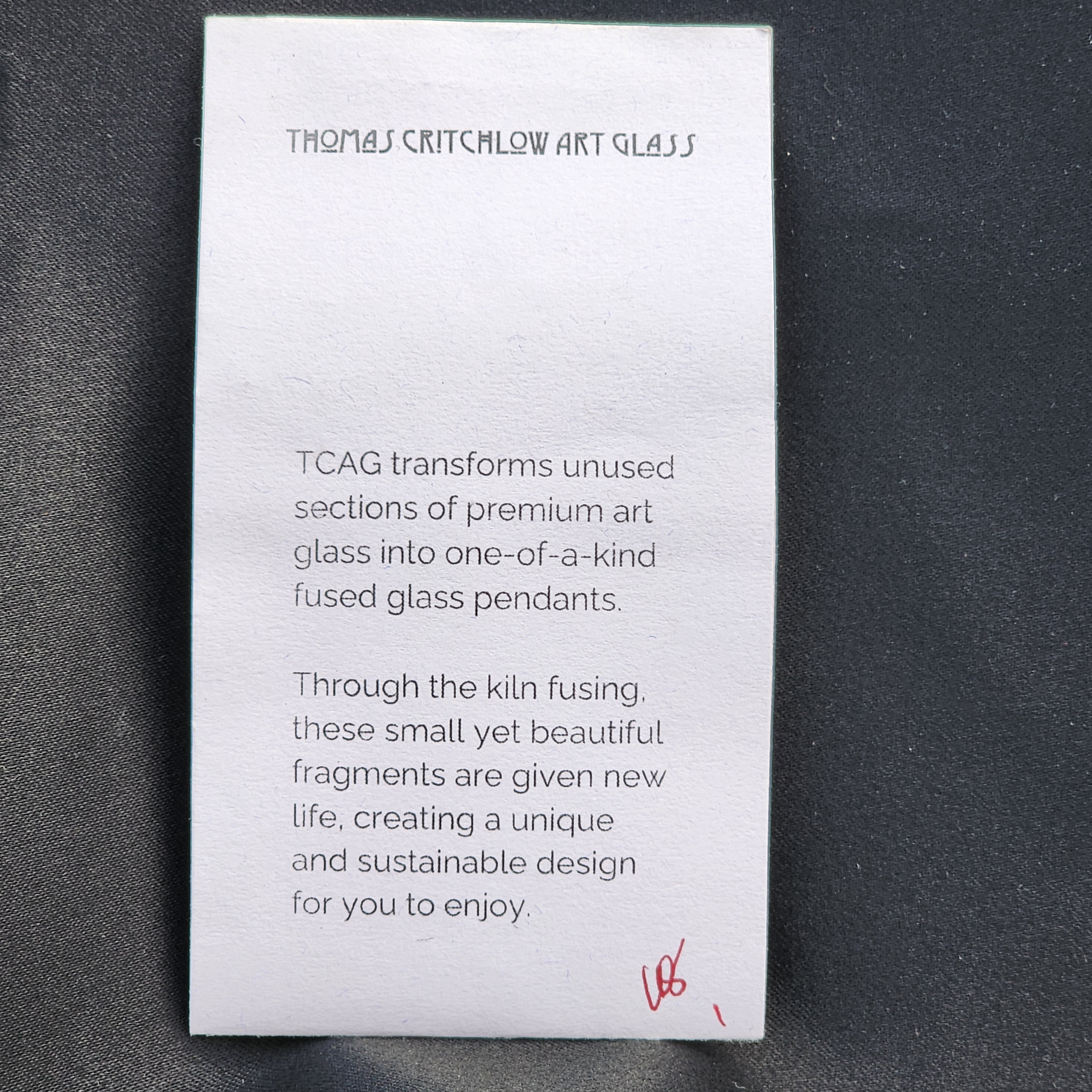 Card with text about Thomas Crichtlow Art Glass on a dark background