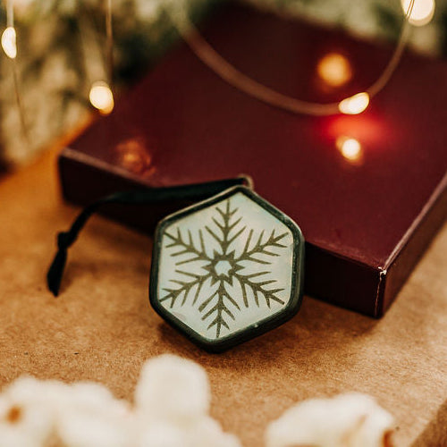 Snowflake hexagon ornament on holiday background