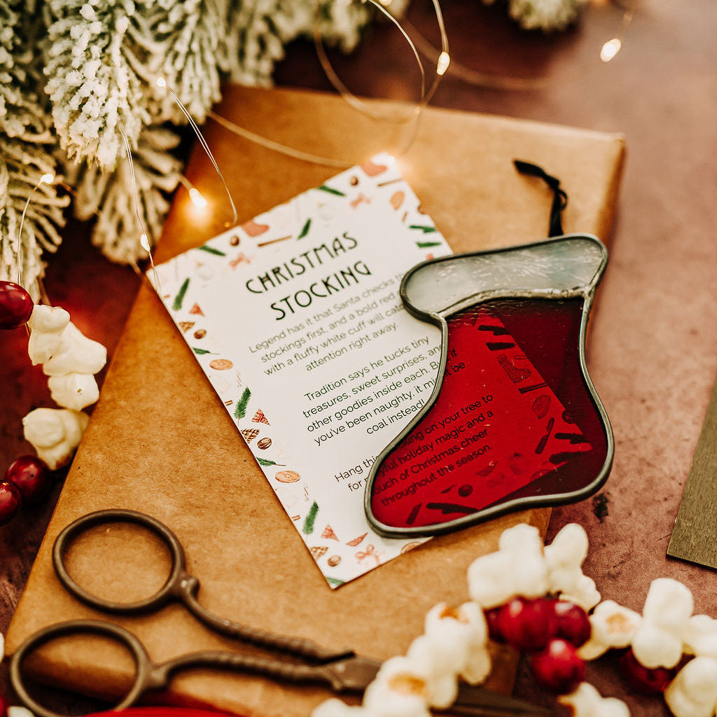 Red and white stained glass christmas stocking on a holiday background