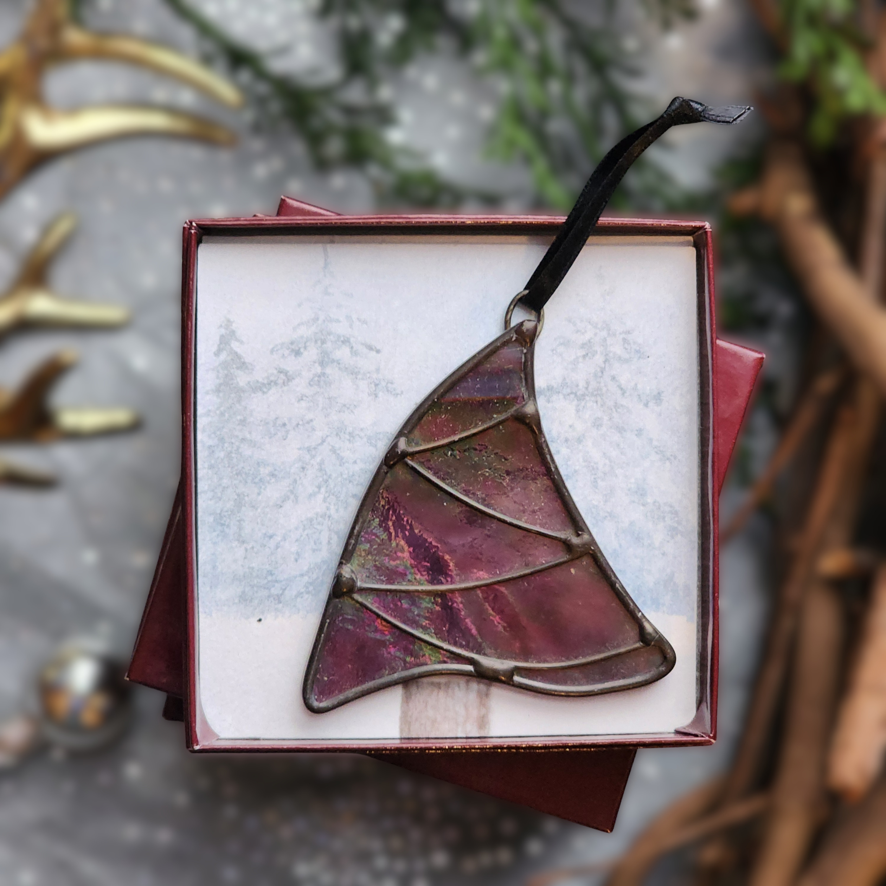 Iridescent Purple Whimsical Christmas Tree stained glass ornament in a gift box on a festive background