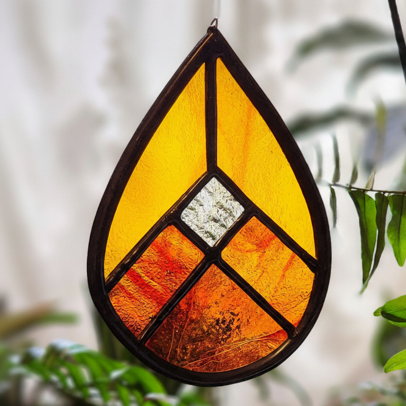Red orange geometric suncatcher on blurred background